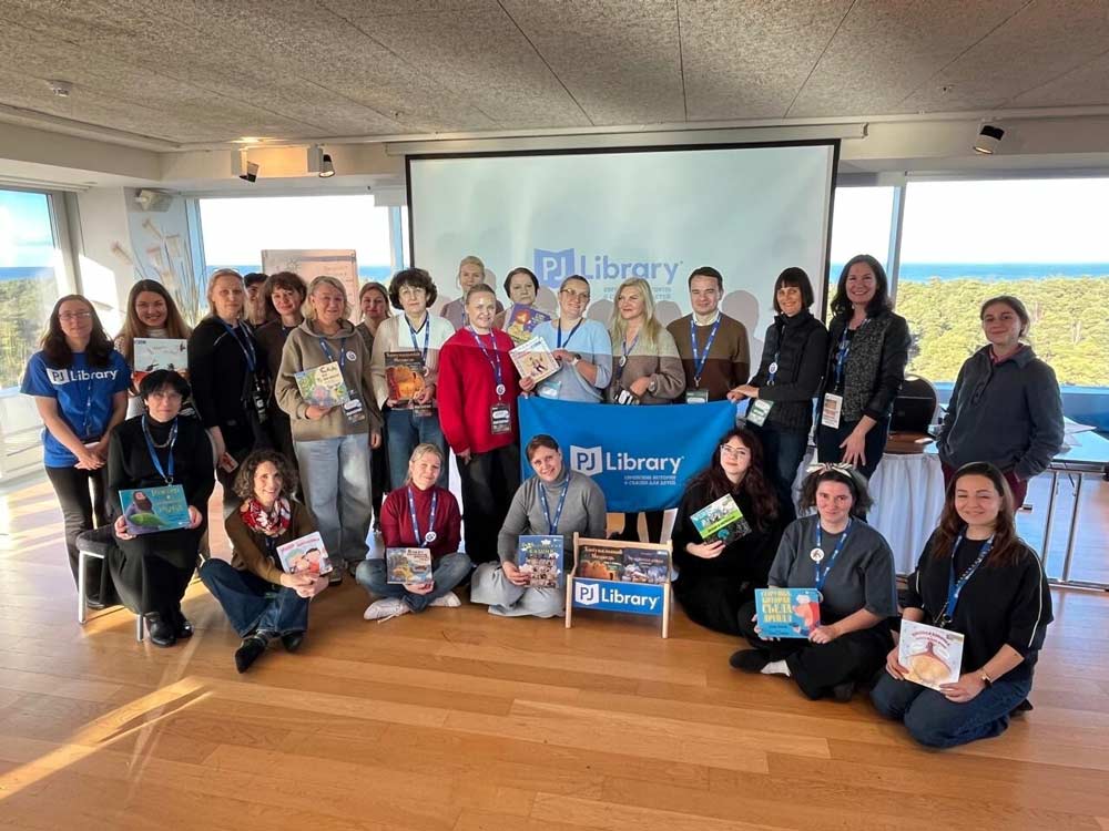 Group of people posing with PJ Library books