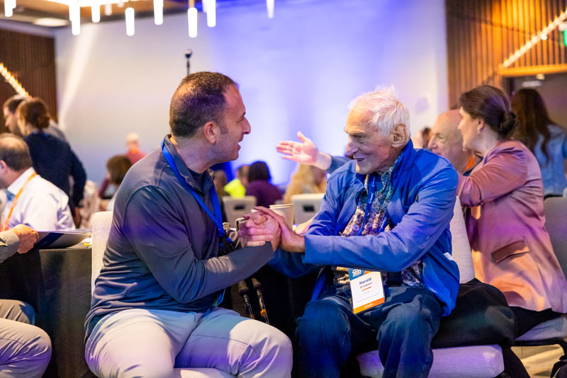 Harold Grinspoon speaking with attendee of the JCamp 180 annual conference